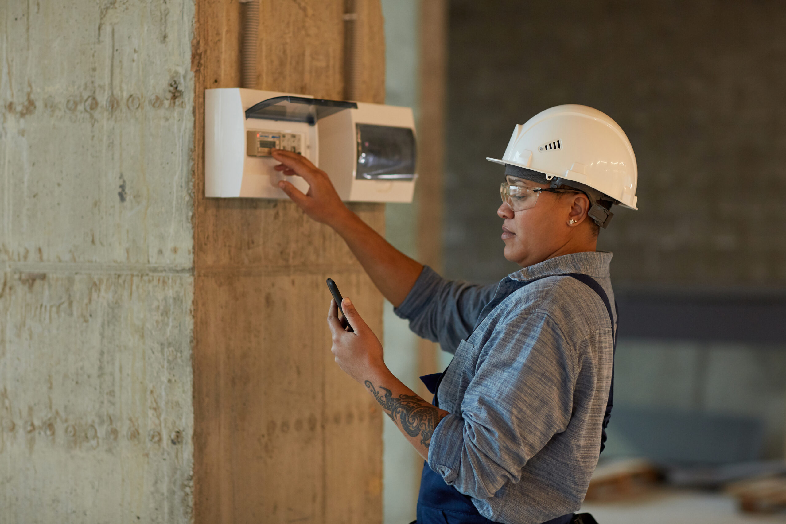 Licensed electrician inspecting a switchboard