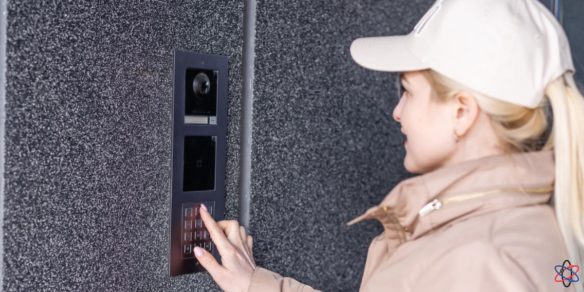 A woman examines a video doorbell, highlighting the importance of security and ongoing maintenance for alarm systems.