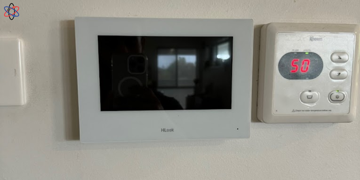 A wall-mounted electronic device displaying a digital clock, highlighting its role in access control systems.