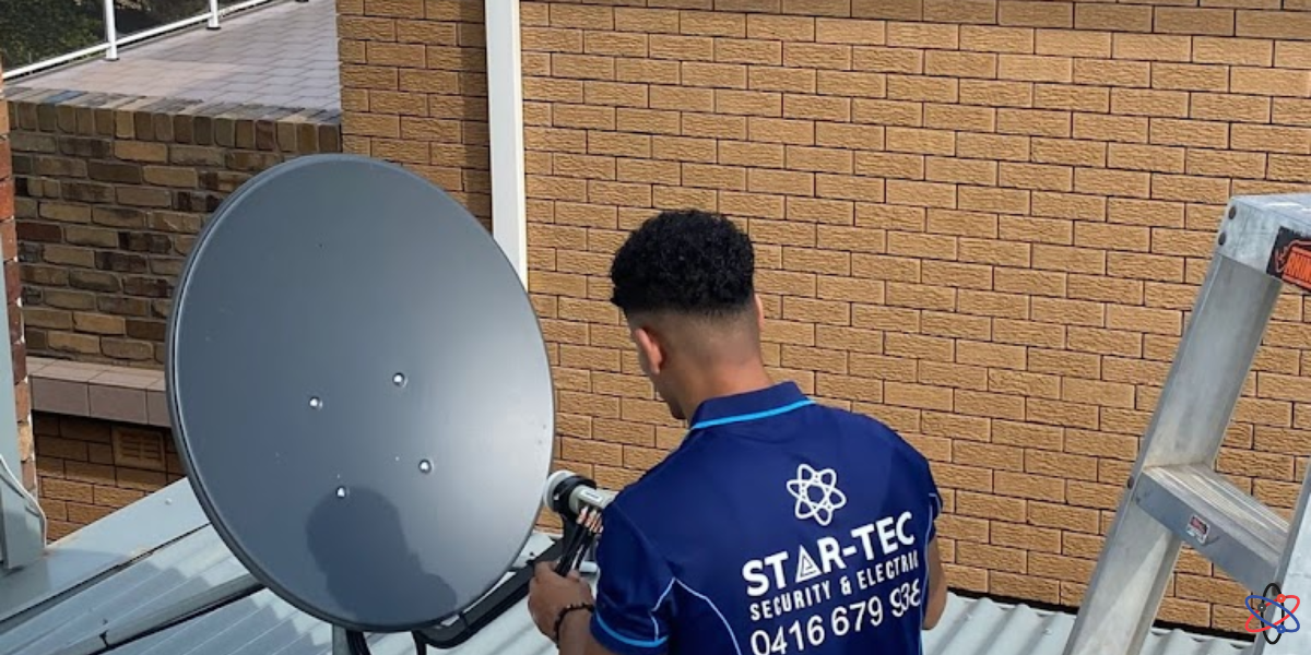 A technician repairs a satellite dish on a rooftop, ensuring reliable service for surveillance systems.