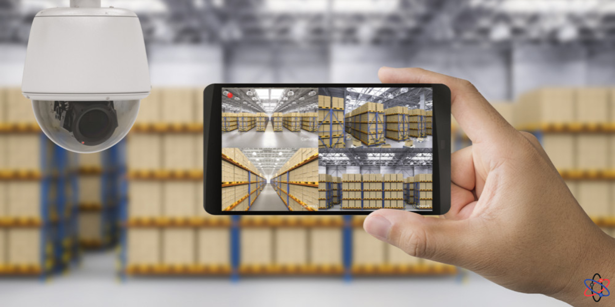 A person holds a camera in front of a warehouse, symbolizing advanced surveillance technology integration.